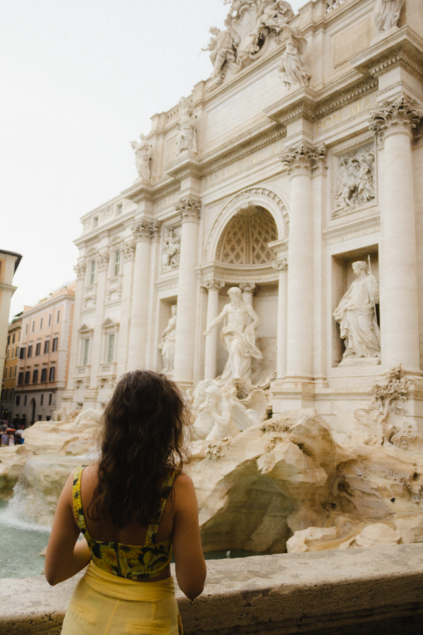 Menina de costas admirando a Fontana de Trevi, Itália